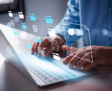 Graphical representation of files and documents laid over an image of hands typing on a laptop.
