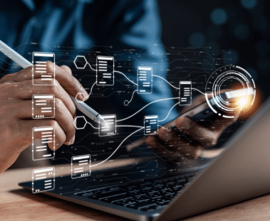 DATA VERIFICATION EXPERTS Digital icons representing different documents overlaid on an image of a person typing on a laptop.